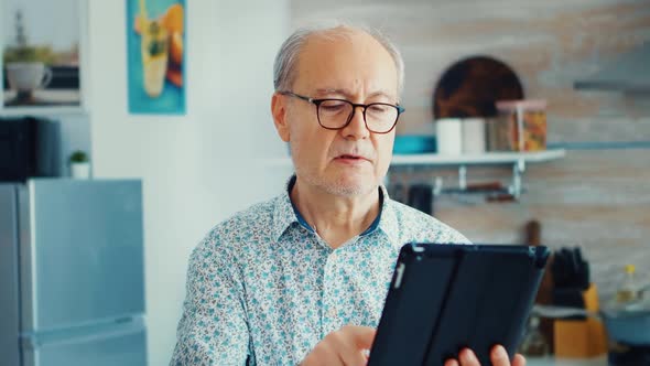 Elderly Man Using Tablet Pc