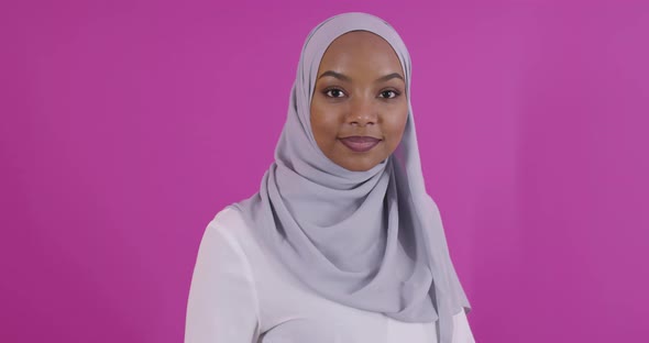 Portrait of Young Modern Muslim Afro Beauty Wearing Traditional Islamic Clothes on Plastic Pink