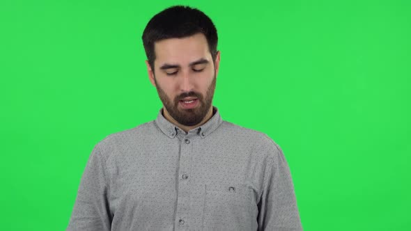 Portrait of Brunette Guy Is Refusing Stress and Taking Situation, Calming Down. Green Screen