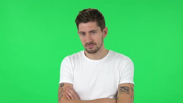 Portrait of Confident Guy Is Looking Straight and Crossing His Arms Over His Chest