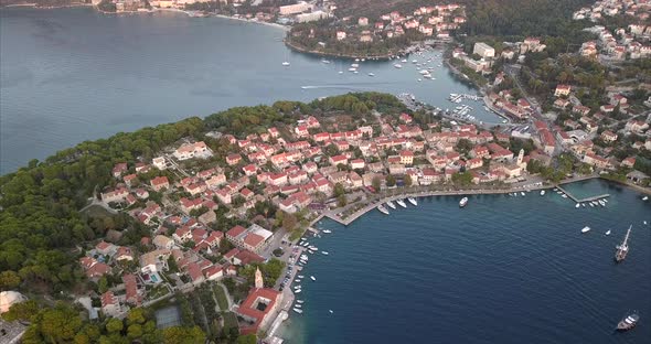 Aerial video over small Croatian coast town during sunset