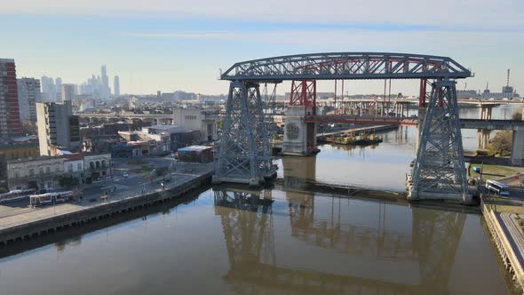 Drone hovering above Matanza river on a sunny day facing the famous historical monument bridge Puent