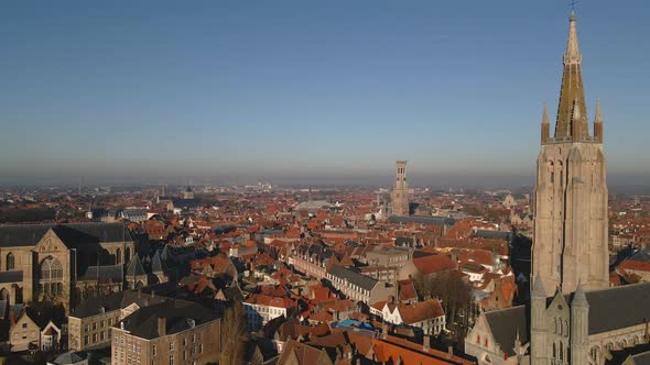 Aerial reveal of buildings around Church of Our Lady Bruges