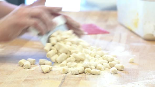 human hand making little piece of a typical italian pasta with flour eggs and water