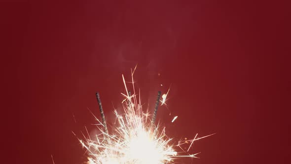 Sparklers Bright Burning Christmas Light on Red Background