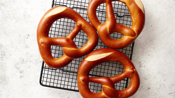 Three German Fresh Baked Pretzel Buns Placed on Steel Grill Frame