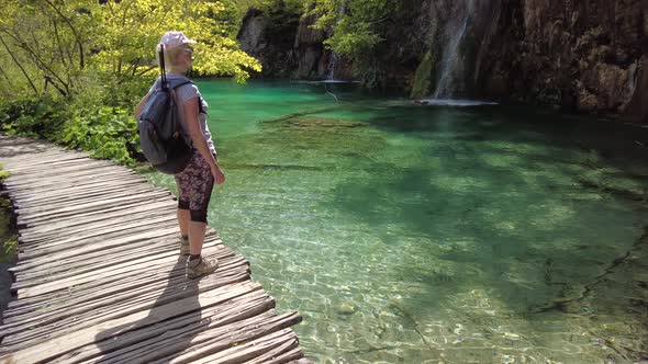 Woman Showing Waterfall in Plitvice Lakes National Park