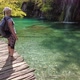 Woman Showing Waterfall in Plitvice Lakes National Park - VideoHive Item for Sale