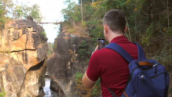 Casual Travel Blogger Shooting Video of Amazing Nature in National Park in Thailand