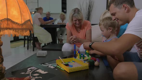 Family and Child Playing with Construction Toy