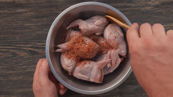 Top View of Raw Quails Marinated in a Bowl with Mustard and Spices