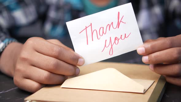 Close Up of Man Hand Reading a Thank you Letter