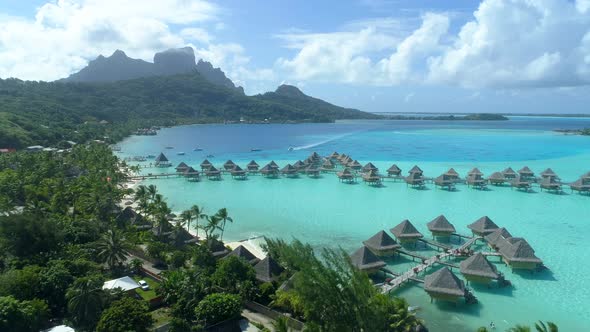 Aerial drone view of a luxury resort and overwater bungalows in Bora Bora tropical island