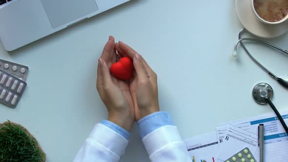 Cardiologist Hands Showing Toy Heart, Disease Diagnostics and Treatment Top View