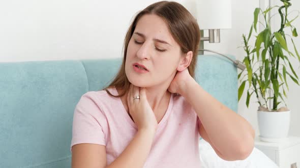 Young Woman in Pajamas Suffering From Pain in the Neck and Back After Sleeping on Uncomfortable Bed