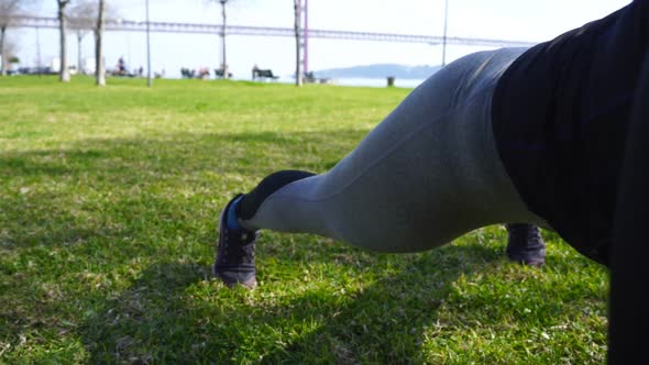 Focused Young Woman Working Out in Park