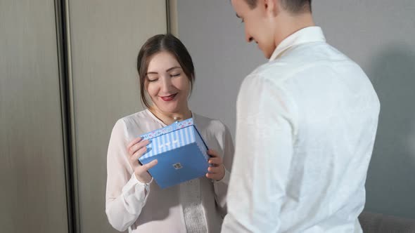 Young Man in Giving Valentine Gift Box to His Girlfriend