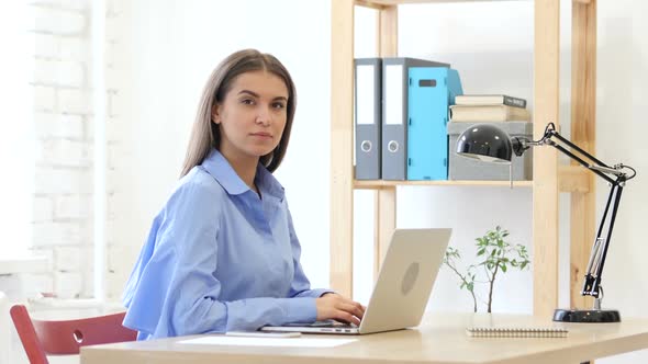 Young Woman Looking at Camera  in Office