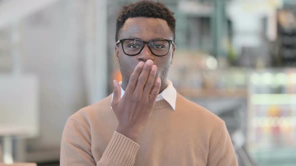 Creative African Man Giving Flying Kiss By Hands