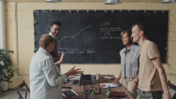 Colleagues High-fiving after Finishing Project