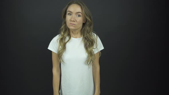 Angry Lady with Long Loose Curly Hair Puts Hands on Hips