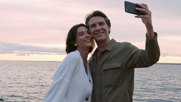 Man and Woman Making Selfie on Sea Coast