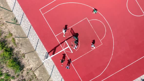 Aerial View of Young Athletes Playing Streetball on an Open Summer Playground