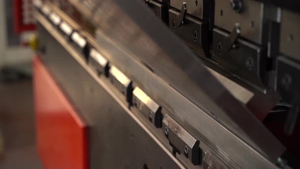 Industrial twisting machine and worker bending metal.