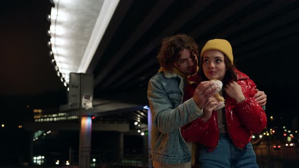 Love Couple Eating Burgers on City Background