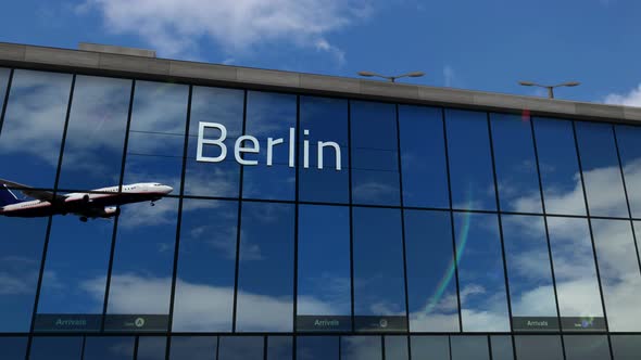 Airplane landing at Berlin Germany airport mirrored in terminal