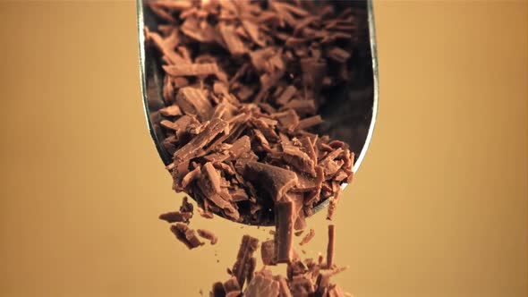 Super Slow Motion Falling of Grated Milk Chocolate From a Scoop