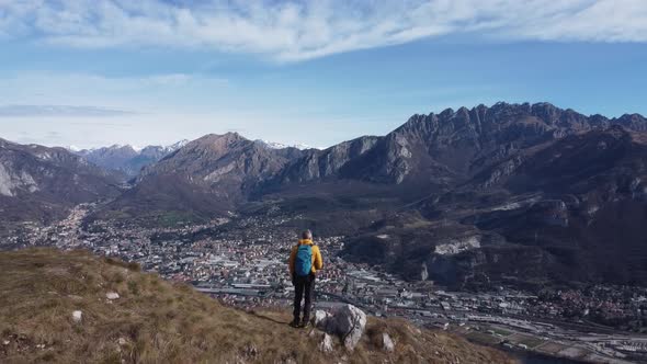 Hiker standing on viewpoint, European Alps, Lecco, Italy