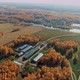 Aerial View of a Farm in a Village Surrounded By Autumn Forest Harvesting Hangar - VideoHive Item for Sale