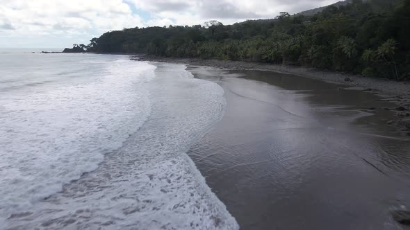 Aerial shot flying over a beach on the coast of Costa Rica. Tropical paradise