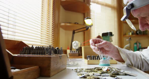 Horologist repairing a watch