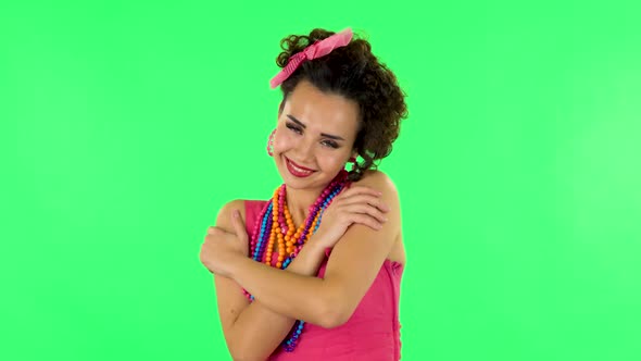 Girl Posing, Gently Stroking Her Skin and Attractively Looking at the Camera. Green Screen