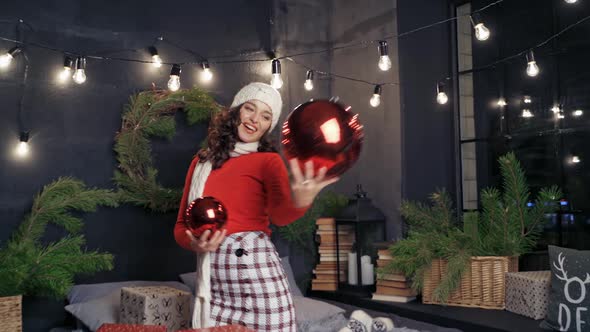 Woman with big christmas balls and presents. 