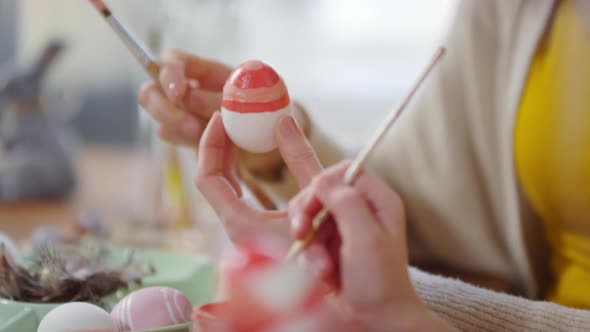 Unrecognizable Mother and Child Decorating Easter Eggs