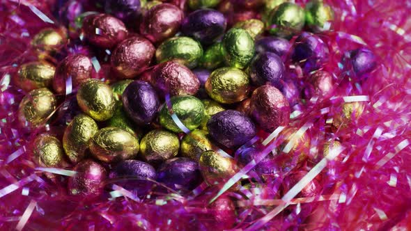 Rotating shot of colorful Easter candies on a bed of easter grass