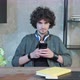 Serious Young Man Sitting in His Home Office and Texting to His Friends - VideoHive Item for Sale
