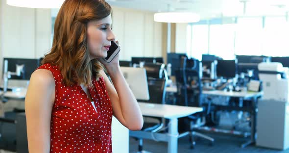 Female executive talking on mobile phone