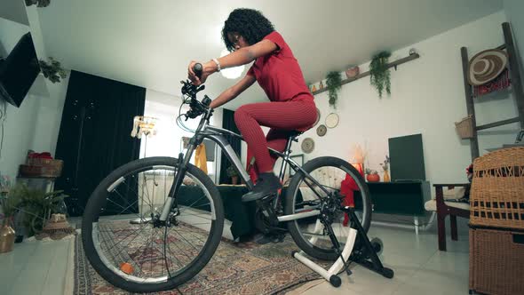 Sport From Home, Fitness at Home. African-american Woman Is Riding an Exercise Bike in Self