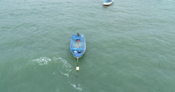 Before the storm. Lonely fishing boats in ocean, sea. alt