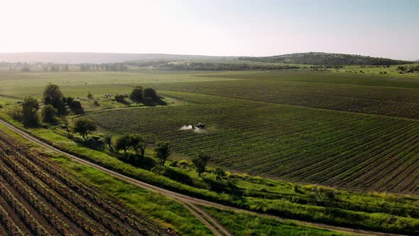 The tractor sprays fertilizes the fields with chemicals to protect crops from weeds and pests.