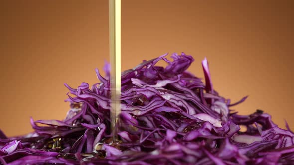 Pour olive oil on salad Purple cabbage. Sliced purple cabbage. Healthy food concept. 4K UHD video