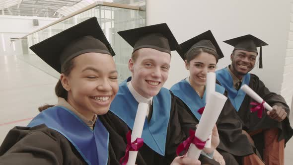 Four Young Classmates Making Selfie during Graduation