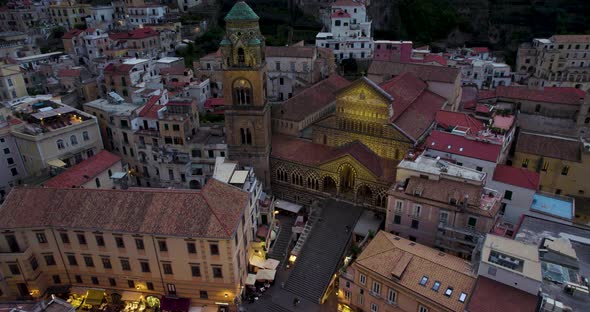 Twilight drone view over medieval Roman Catholic Amalfi Cathedral, Italy