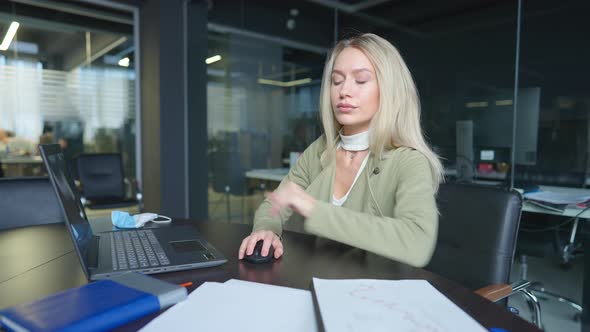 Portrait of Concentrated Confident Caucasian Woman Working in Office Sitting at Table with Laptop