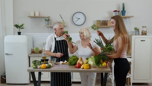 Elderly Couple in Kitchen Receiving Vegetables From Grandchild. Raw Food Healthy Eating Diet