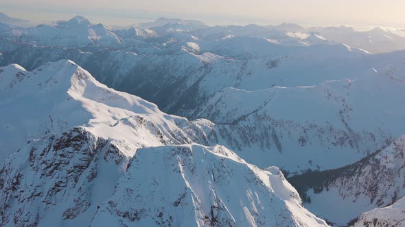 Aerial View From an Airplane of Beautiful Snowy Canadian Mountain Landscape